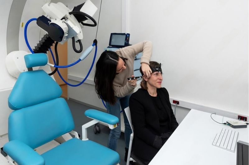 A doctor trying to comfort a patient while talking to her about her case